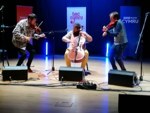 Sizzling VRi - from left, fiddler Patrick Rimes, 'cellist Jordan Price Williams and fiddler Aneirin Jones. Photo by Olly Athelstan-Price